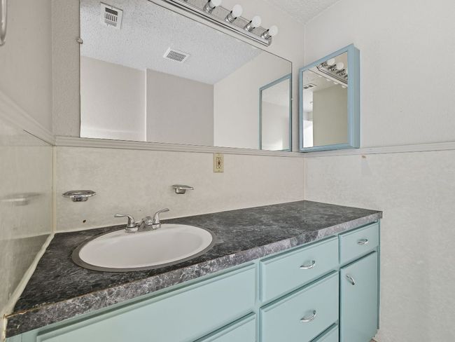 Bathroom with vanity and a textured ceiling | Image 22