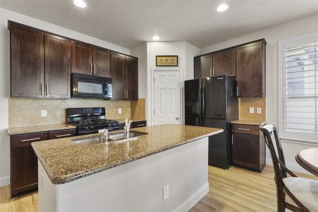 spacious kitchen island makes entertaining a breeze. | Image 9