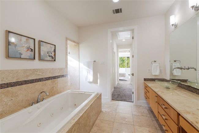 Full bath with a tub with jets, vanity, baseboards, recessed lighting, and tile patterned flooring | Image 20