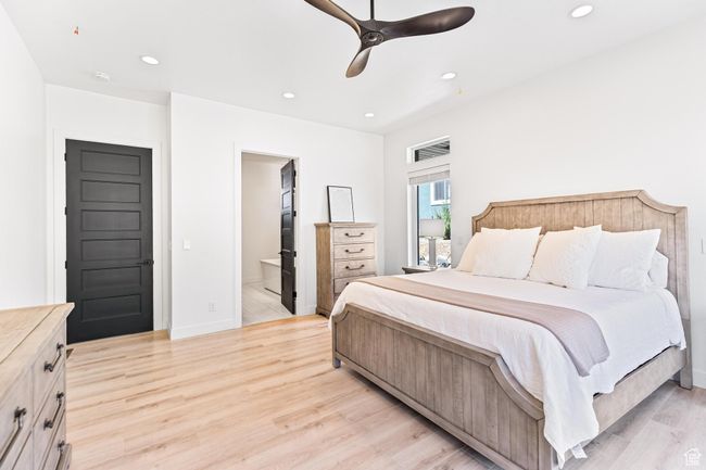 Bedroom featuring baseboards, light wood-type flooring, ensuite bath, and recessed lighting | Image 20