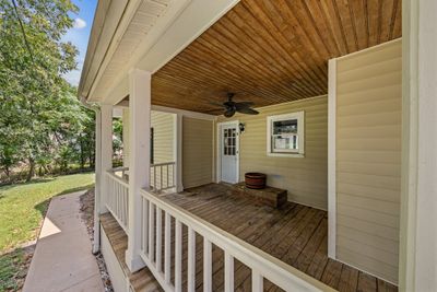 Be welcomed onto the front covered porch for Unit B. Enjoy sitting and enjoying your morning beverage and just listening to the sound of nature. | Image 2