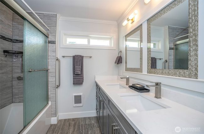 The guest bath has been updated with new lighting, cabinetry, mirrors, and Quartz counters. It also includes a large walk-in shower and a bathtub. We hope your guests enjoy it! | Image 17