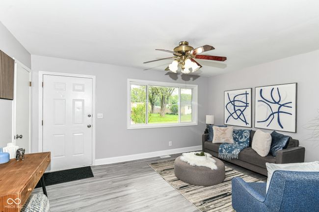 living room featuring a ceiling fan, wood finished floors, and baseboards | Image 7