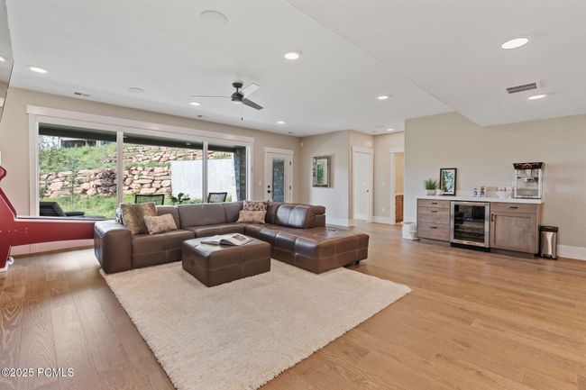 Lower level family room with dry bar and beverage cooler | Image 17