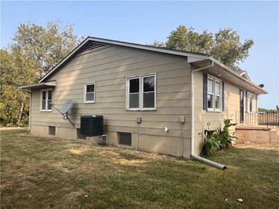 View of side of property featuring a lawn and central AC unit | Image 2