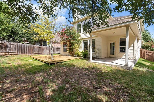 Rear view of property with a fenced backyard, a wooden deck, roof with shingles, and a patio area | Image 29