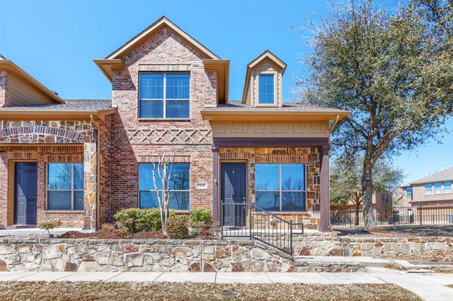 View of front of property featuring brick siding, a shingled roof, and fence | Image 35