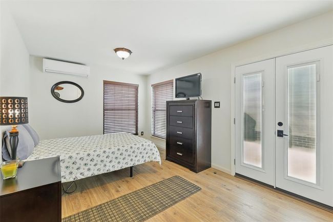 The mother in-law suite also has luxury vinyl plank floors (2023) and access to the back patio through the French door. | Image 20