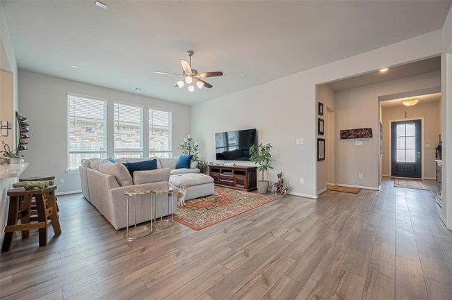 Large living area with three double pane windows and high ceilings. | Image 17