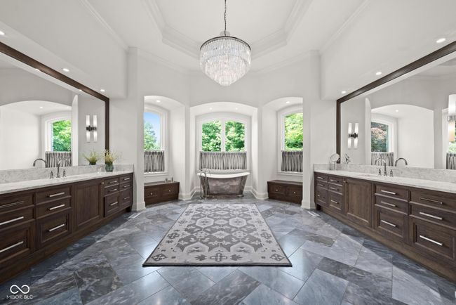 primary bathroom with two vanities, a freestanding tub | Image 27