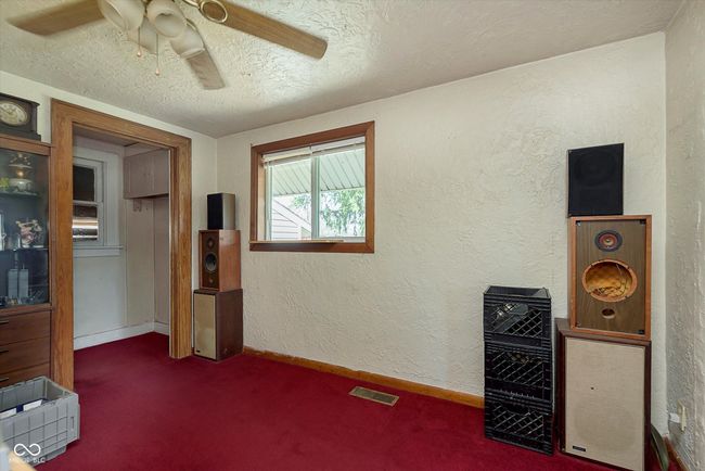 carpeted bedroom with visible vents, baseboards, ceiling fan, a textured wall, and a textured ceiling | Image 8