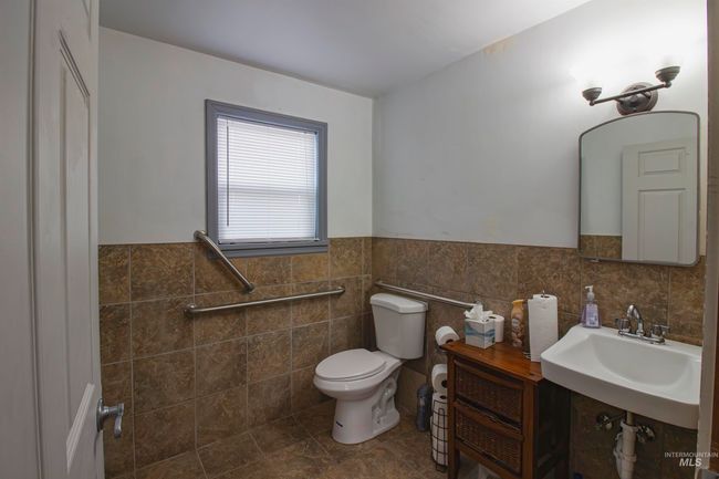 Bathroom featuring tile walls and a wainscoted wall | Image 12