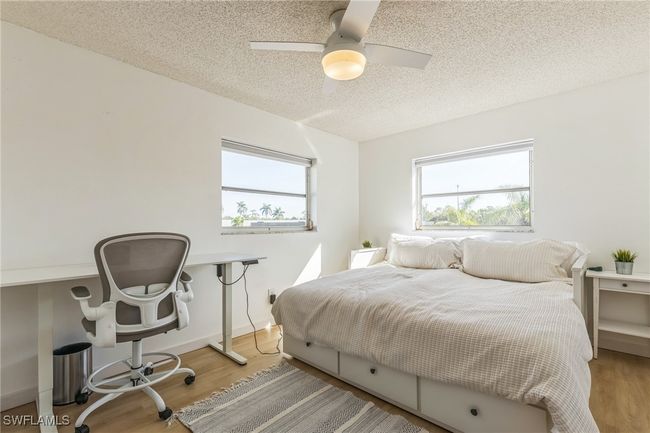 Bedroom featuring a ceiling fan, a textured ceiling, and wood finished floors | Image 29