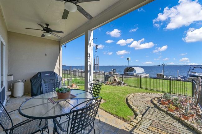 The covered patio complete with propane grill and beautifully manicured yard is a perfect spot for entertaining family and friends. | Image 25