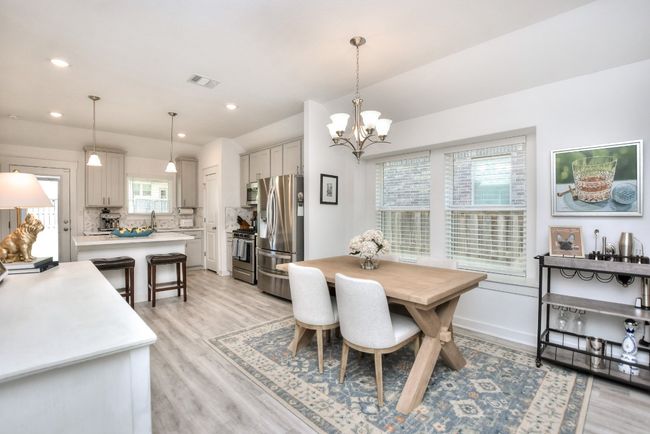 Dining room featuring light wood-type flooring, baseboards, a chandelier, recessed lighting, and visible vents | Image 4