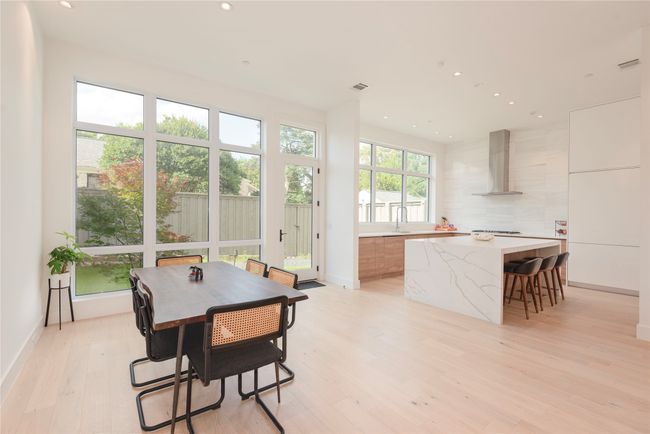 Dining area is open to the kitchen with views of the backyard and patio area. | Image 7