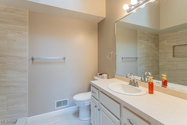 Bathroom featuring vanity and a tile shower | Image 28