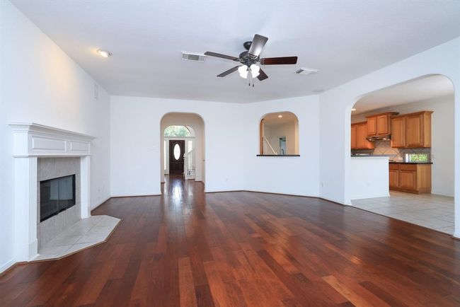 Open archway from kitchen sink to stay in tune with family room activities | Image 12