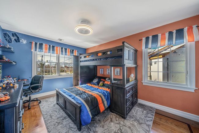 Bedroom featuring baseboards, visible vents, and wood finished floors | Image 22