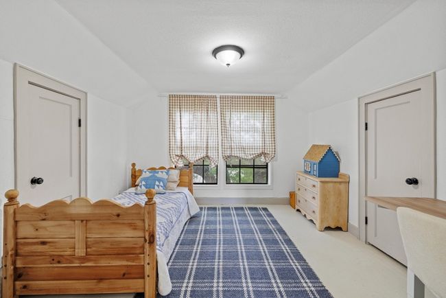 2nd Bedroom featuring lofted ceiling with large windows | Image 17