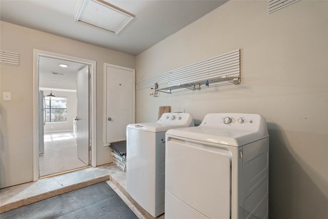 Dedicated laundry area in the garage with washer/dryer included, wall-mounted storage | Image 8