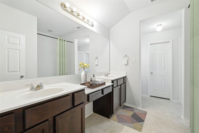 Full bath featuring tile patterned floors, an enclosed shower, a sink, and double vanity | Image 30