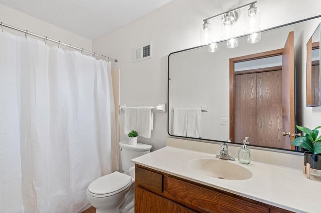Beautiful full bathroom with ample counterspace and a massive mirror. | Image 14