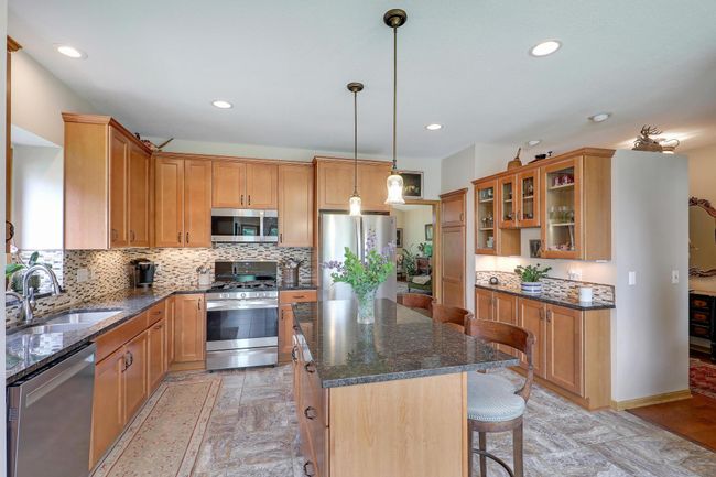 Beyond the island is a pantry and extra counter and cabinet space. | Image 18