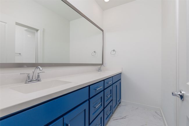 Bathroom with marble look tile flooring and double vanity | Image 21