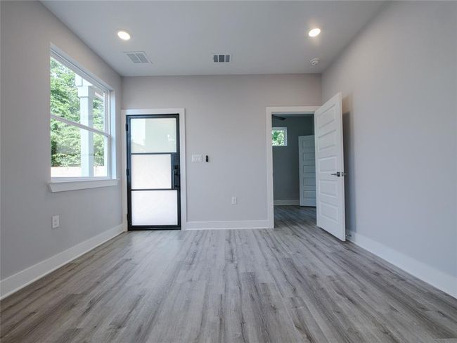 Unfurnished room featuring wood finished floors, recessed lighting, and a smoke detector | Image 4