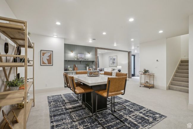 Dining room with recessed lighting, light carpet, stairway, and baseboards | Image 39