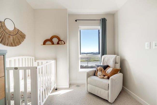 Carpeted bedroom featuring baseboards and a crib | Image 23