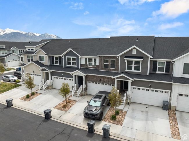 Multi unit property with an attached garage, a residential view, a mountain view, and concrete driveway | Image 38