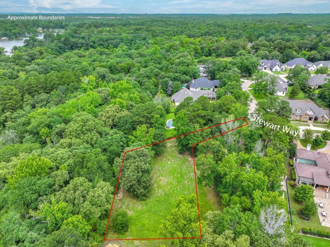 Aerial view of residential area with a heavily wooded area and property parcel outlined | Image 6