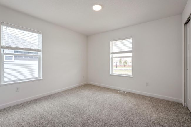 Photo is of the actual home. All three secondary bedrooms come with a spacious closet! | Image 11