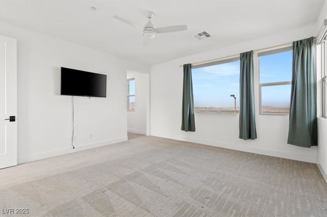Empty room featuring baseboards, visible vents, light carpet, and a ceiling fan | Image 34