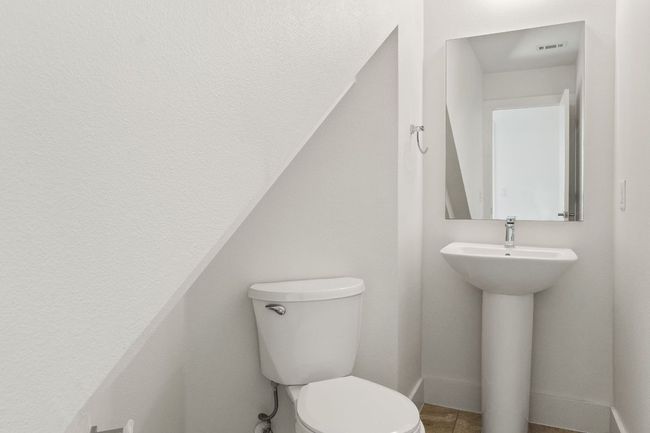 Half bath on 1st floor between the garage and the stairs. | Image 8