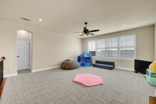 Playroom with arched walkways, carpet flooring, ceiling fan, and recessed lighting | Image 34