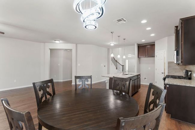 Dining space featuring visible vents, a chandelier, baseboards, recessed lighting, and dark wood-type flooring | Image 17