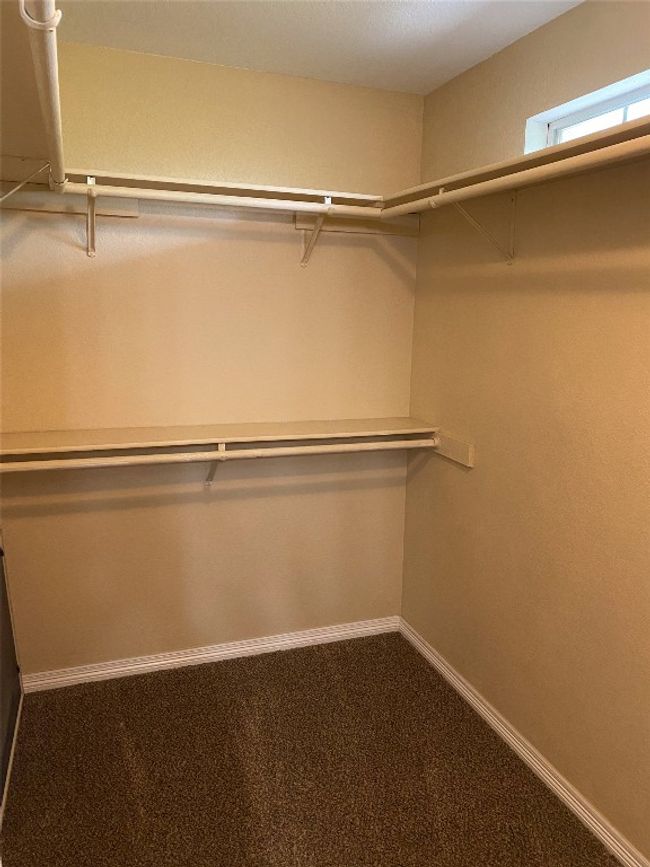 Walk in closet featuring carpet | Image 19