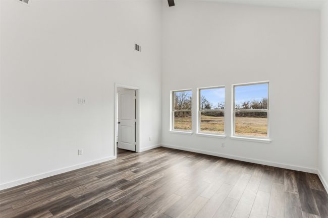 Empty room with a high ceiling and dark wood finished floors | Image 29
