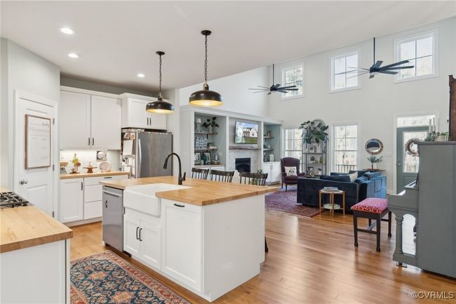 Kitchen with a sink, fridge with ice dispenser, ceiling fan, and butcher block countertops | Image 8