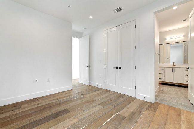 Unfurnished bedroom with light wood-style flooring, recessed lighting, and a closet | Image 23