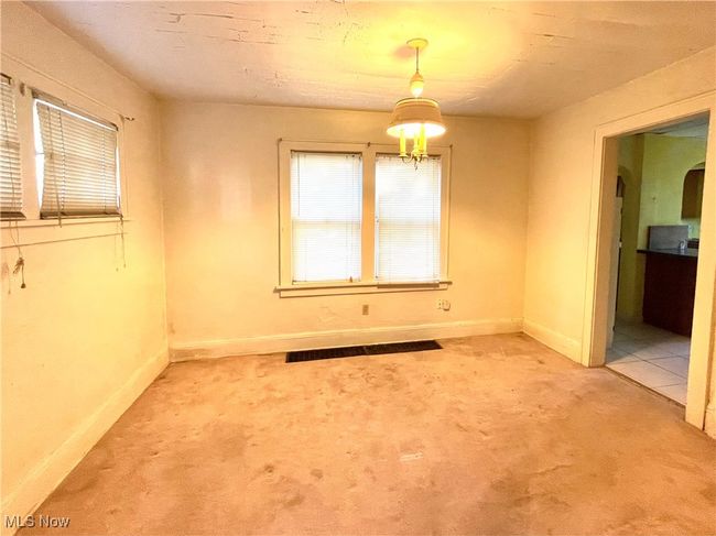 Spare room featuring light carpet and baseboards | Image 5