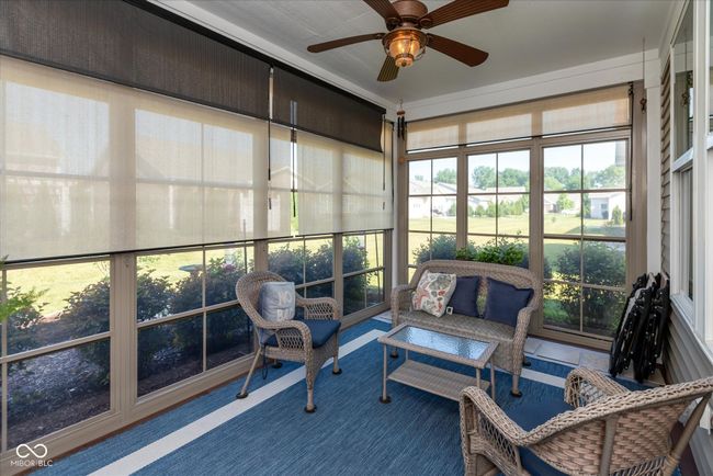 3 season sunroom featuring ceiling fan and an outdoor living space that seller uses nearly year round | Image 4