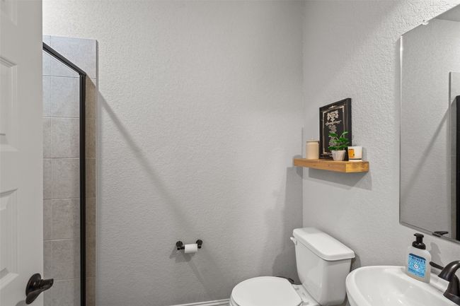 Bathroom with a sink and tiled shower | Image 26