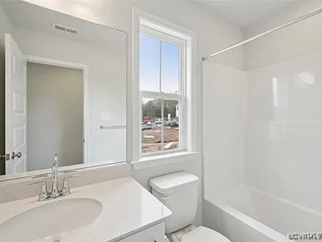 Bathroom featuring vanity and shower / bathtub combination | Image 26