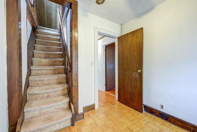 Stairway featuring baseboards and a textured ceiling | Image 34