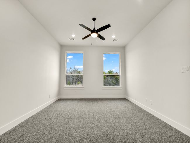 Carpeted empty room featuring ceiling fan | Image 18