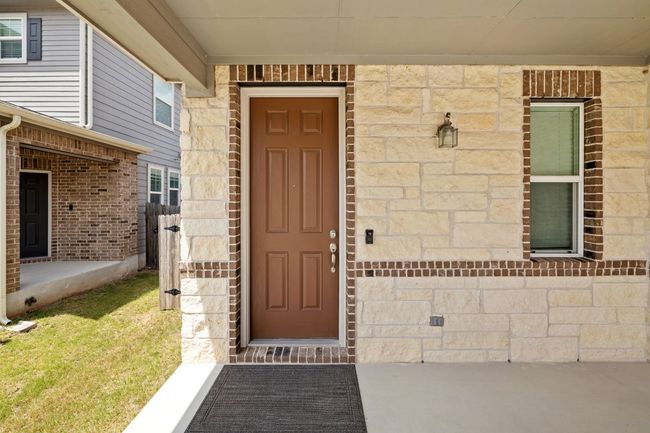 View of exterior entry featuring stone siding | Image 4